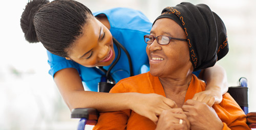 Female nurse hugging female patient